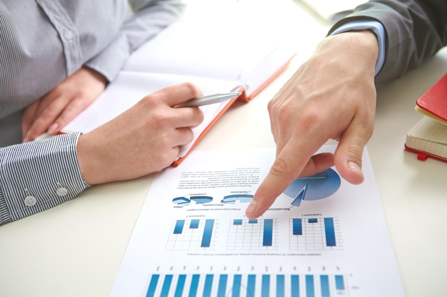 Professional financial workspace with charts and modeling tools